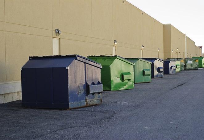 a red construction dumpster placed in front of a building under construction in Camarillo